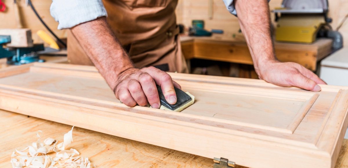 detail of caucasian carpenter at work in a workshop
